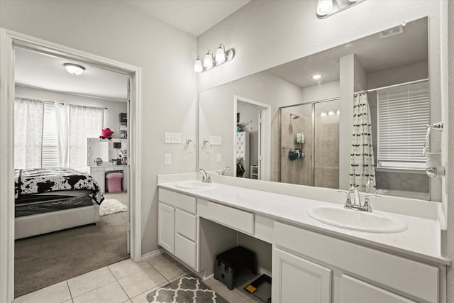 bathroom with walk in shower, vanity, and tile patterned floors