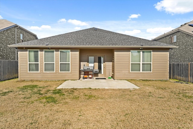 rear view of property with a lawn and a patio area