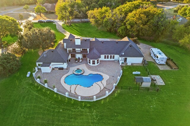 pool at dusk featuring an in ground hot tub and a patio