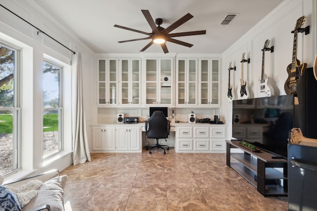 office featuring ornamental molding, built in study area, and visible vents