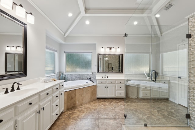 bathroom featuring lofted ceiling, two vanities, a sink, a shower stall, and a bath