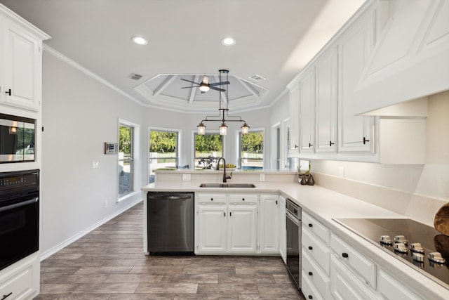 kitchen featuring light countertops, appliances with stainless steel finishes, a sink, and white cabinetry