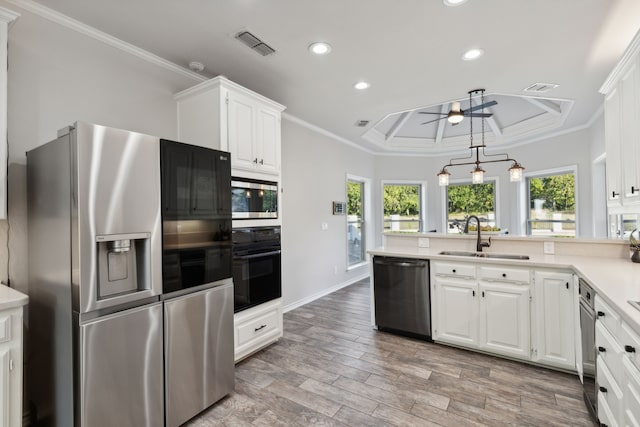 kitchen featuring a sink, stainless steel appliances, light countertops, and white cabinetry