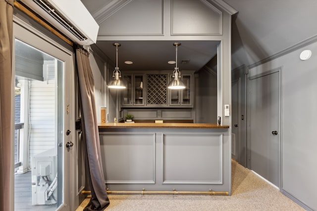 bar featuring hanging light fixtures, a wall unit AC, a dry bar, and crown molding