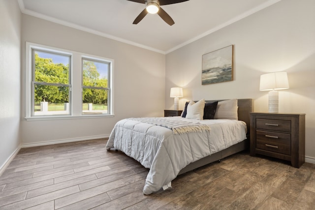 bedroom featuring ornamental molding, baseboards, and wood finished floors