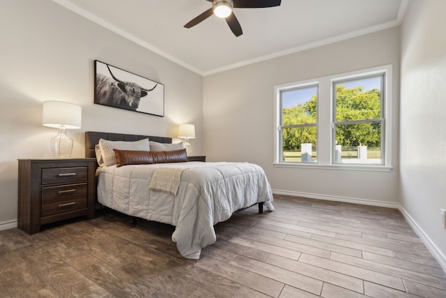 bedroom featuring dark wood-style floors, baseboards, ornamental molding, and ceiling fan