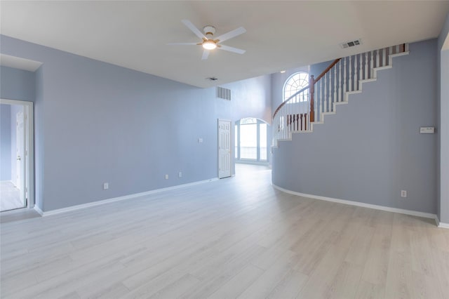 unfurnished living room featuring ceiling fan and light hardwood / wood-style floors