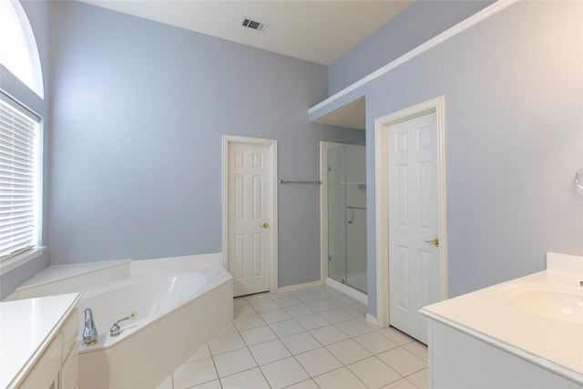 bathroom with vanity, tile patterned flooring, and shower with separate bathtub