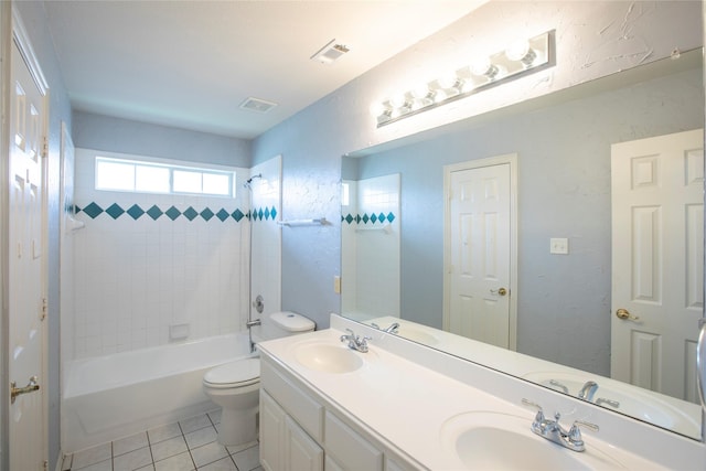 full bathroom with tile patterned floors, toilet, vanity, and tiled shower / bath