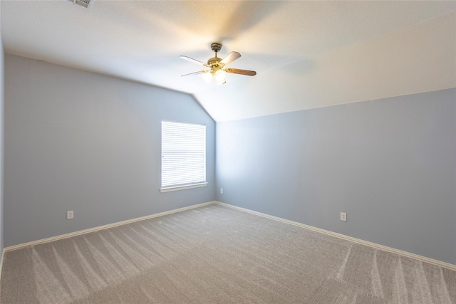 unfurnished room with ceiling fan, carpet, and vaulted ceiling