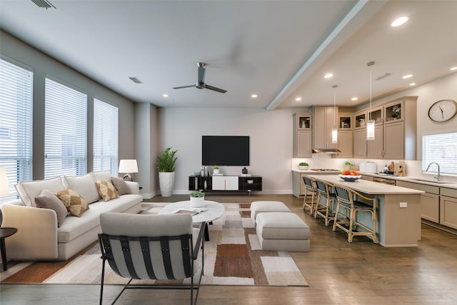 living area featuring dark wood-style floors, a ceiling fan, a wealth of natural light, and recessed lighting