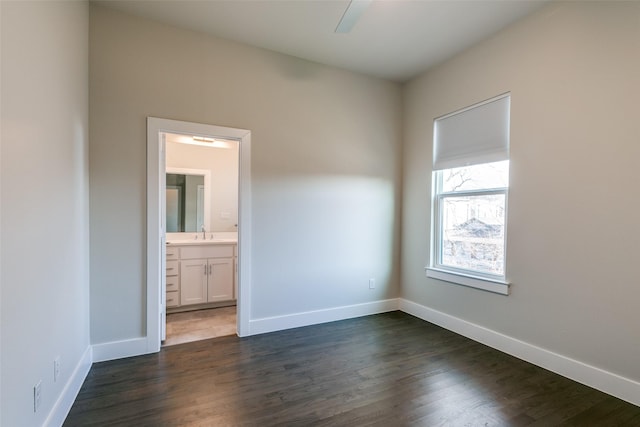 empty room featuring sink and dark hardwood / wood-style floors