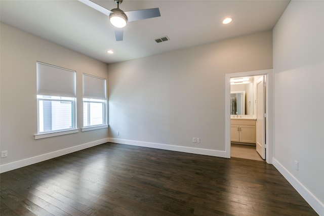 empty room featuring ceiling fan and dark wood-type flooring