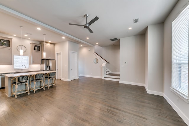 living room with ceiling fan, sink, and dark hardwood / wood-style flooring