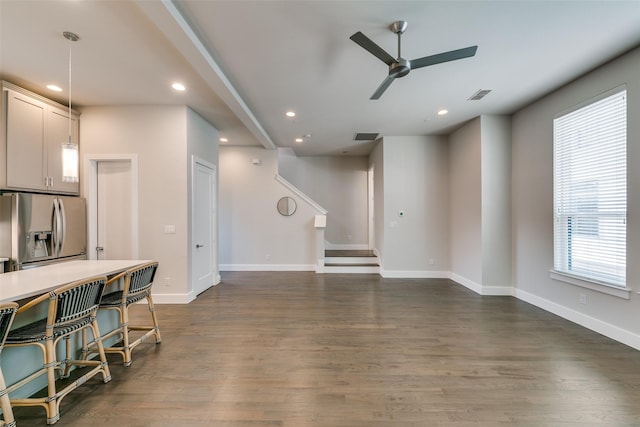 living room with ceiling fan and dark hardwood / wood-style floors