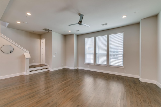 unfurnished living room with ceiling fan and dark hardwood / wood-style floors