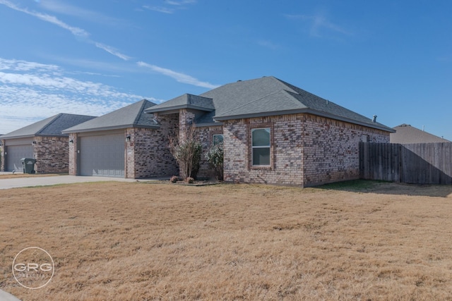 view of front of home with a front lawn and a garage