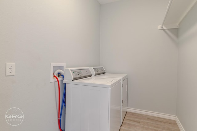 laundry area featuring light hardwood / wood-style floors and independent washer and dryer