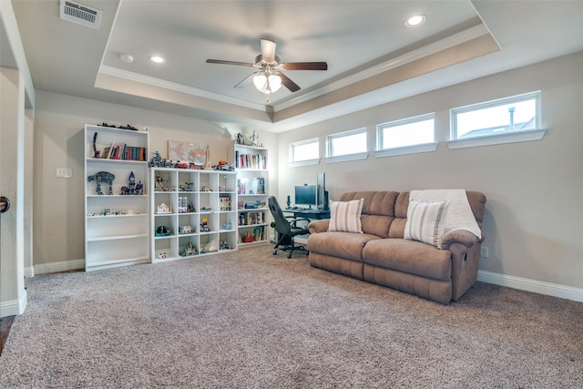 living room with ceiling fan, a raised ceiling, and carpet flooring