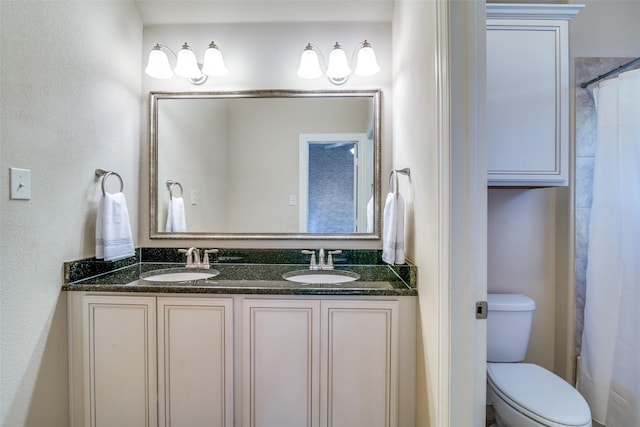 bathroom with toilet, walk in shower, and vanity