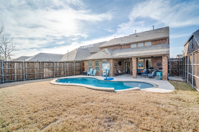 view of pool with a patio area and a lawn