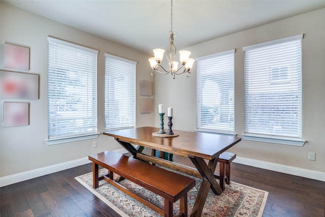 dining room with an inviting chandelier and dark hardwood / wood-style flooring