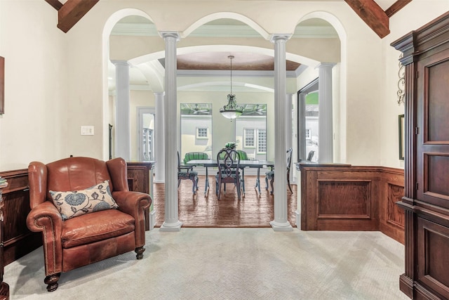 interior space with beam ceiling, decorative columns, and ornamental molding