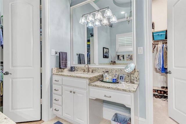 bathroom featuring crown molding and vanity