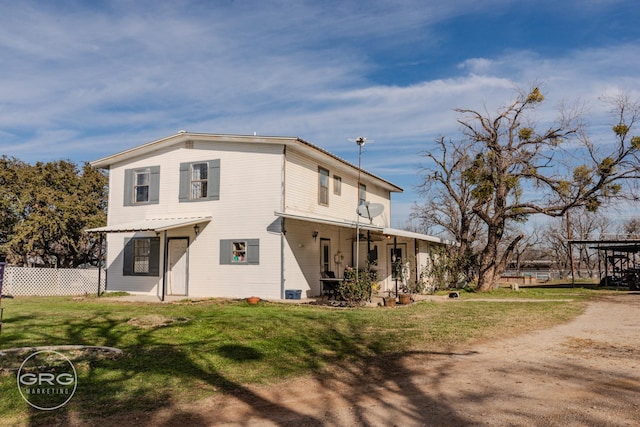 back of property featuring a lawn