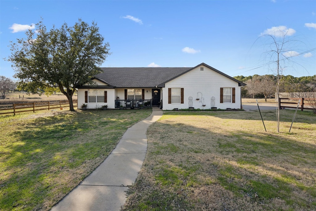 view of front of house featuring a front lawn and covered porch