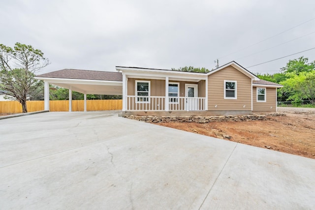 view of front of home featuring a porch and a carport