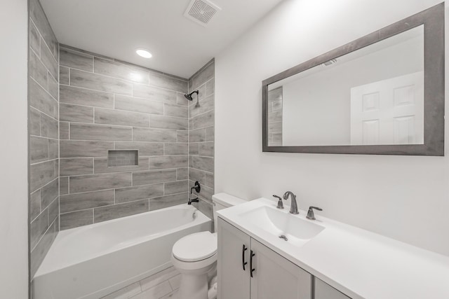 full bathroom with toilet, tiled shower / bath combo, and vanity