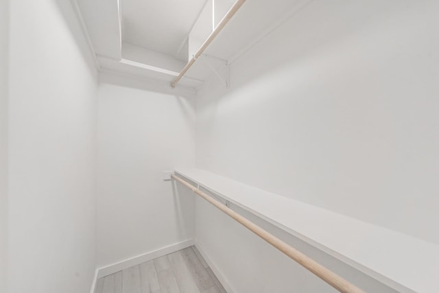 walk in closet featuring light hardwood / wood-style flooring