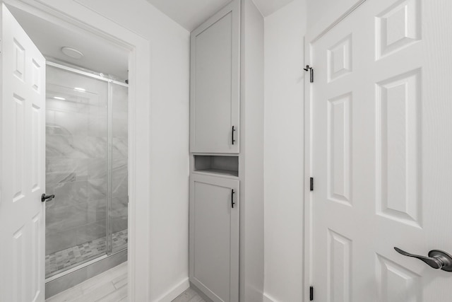 bathroom with a shower with shower door