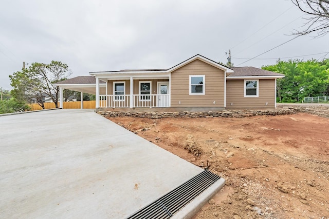 ranch-style house with a carport and covered porch