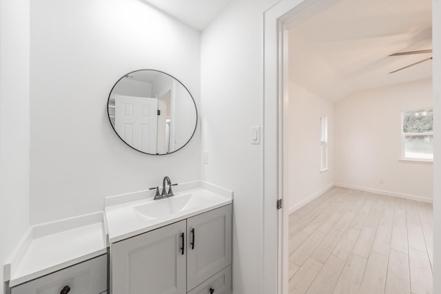 bathroom featuring lofted ceiling, vanity, ceiling fan, and wood-type flooring