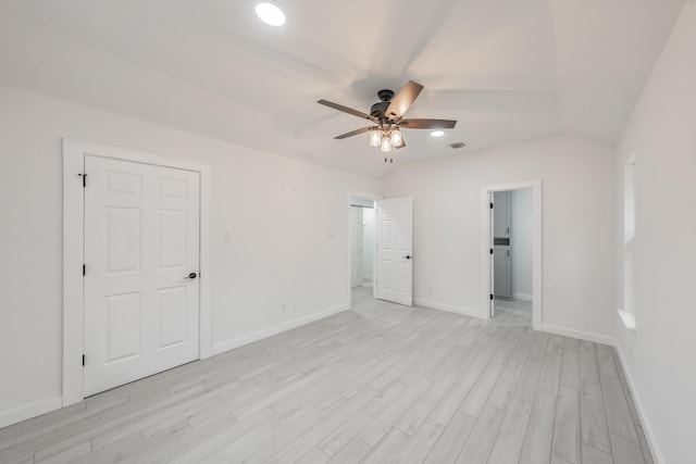 empty room featuring ceiling fan, light hardwood / wood-style floors, and lofted ceiling