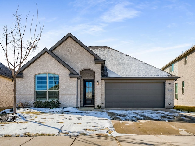 french provincial home featuring a garage