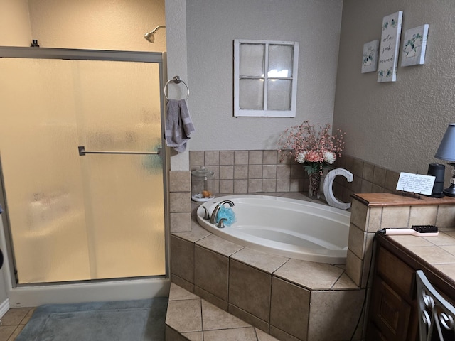 bathroom featuring tile patterned flooring, vanity, and plus walk in shower