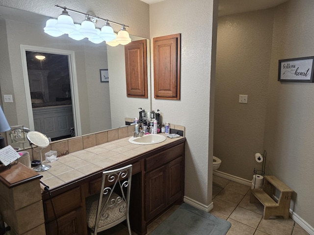 bathroom featuring tile patterned floors, vanity, and toilet