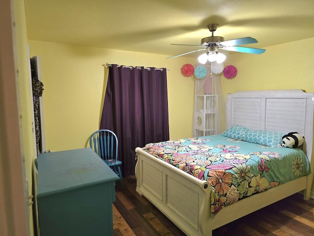 bedroom with ceiling fan and dark wood-type flooring