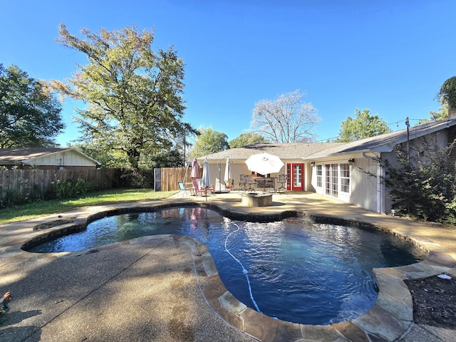 view of swimming pool featuring an outdoor fire pit and a patio