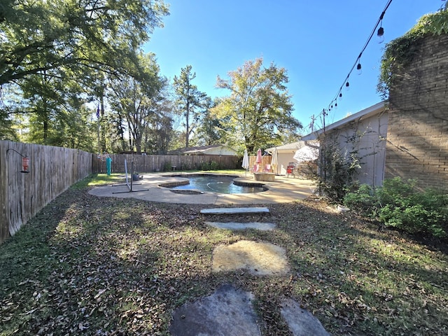 view of yard with a fenced in pool and a patio area