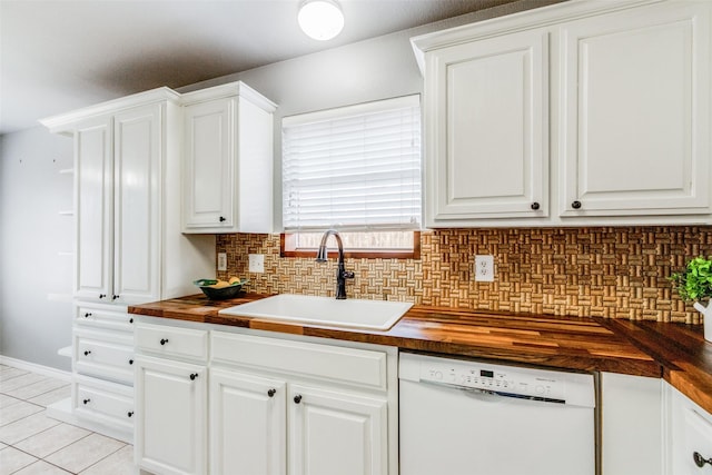 kitchen with wood counters, dishwasher, white cabinets, and sink