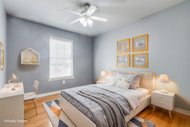 bedroom with ceiling fan and light hardwood / wood-style flooring