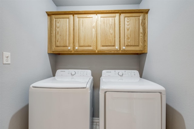 laundry room with cabinets and separate washer and dryer