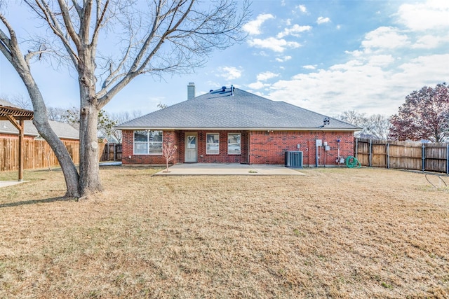 rear view of house featuring a patio area, cooling unit, and a yard