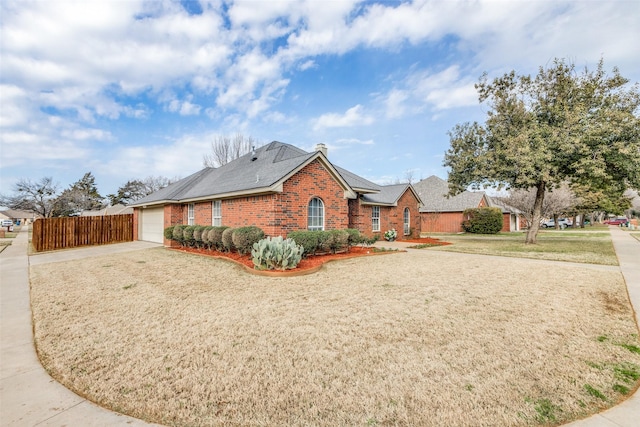 view of front of house with a front yard and a garage