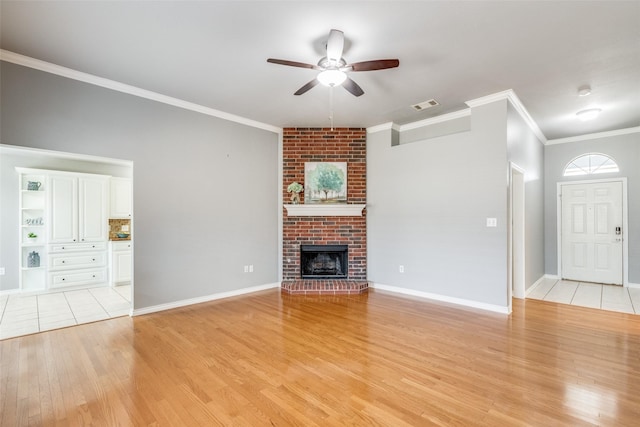 unfurnished living room with ceiling fan, light hardwood / wood-style flooring, ornamental molding, and a fireplace