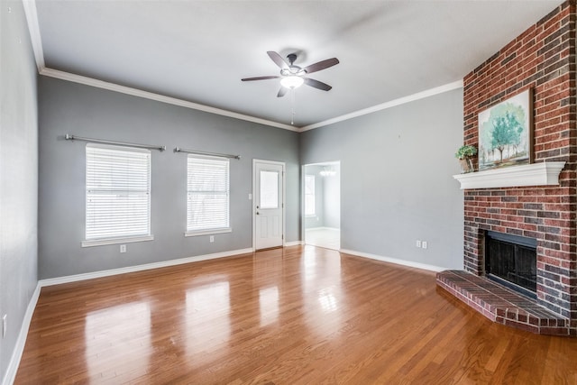 unfurnished living room featuring ceiling fan, ornamental molding, a fireplace, and hardwood / wood-style floors